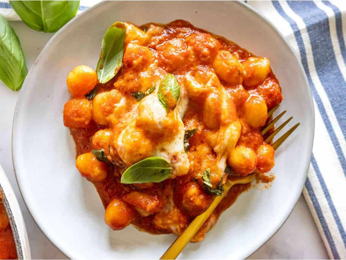 Step Picture 4 Gnocchi alla sorrentina served on a plate with basil and olive oil