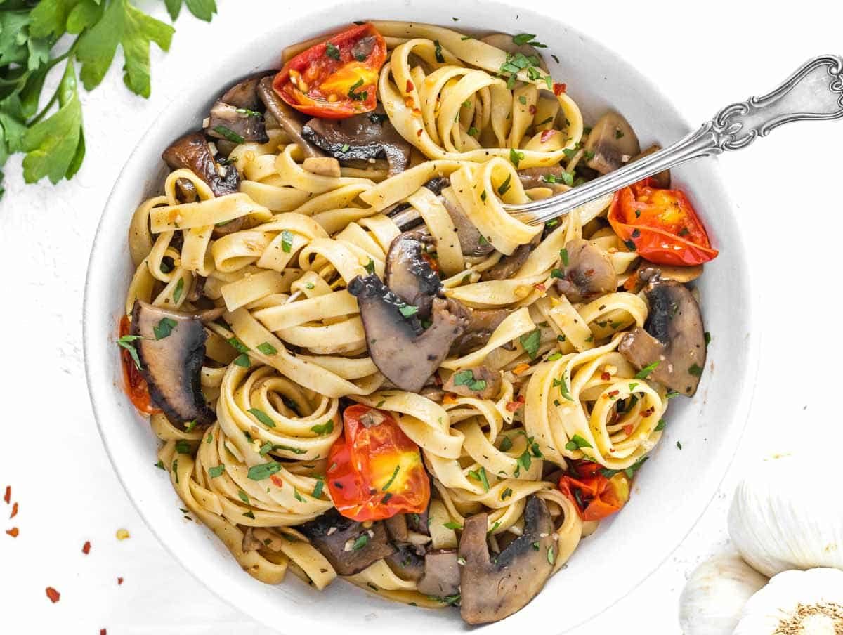 vegan mushroom pasta with cherry tomatoes and parsley