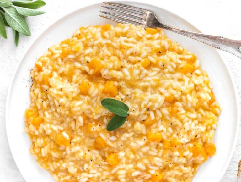 a portion of butternut squash risotto and sage on a plate