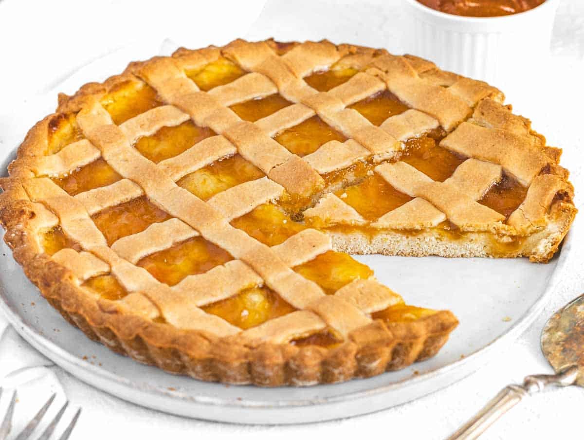 Crostata with slice on a white plate