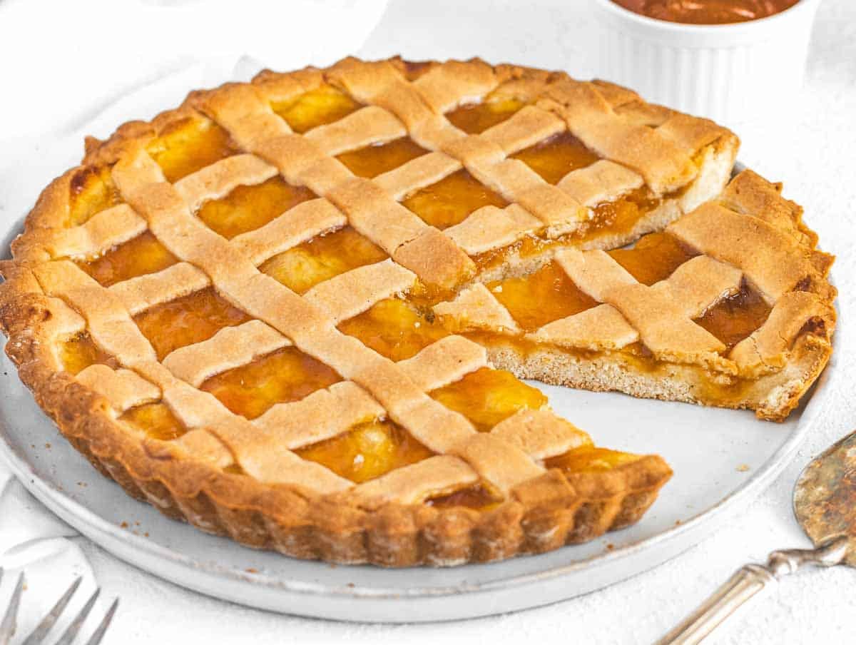 Crostata with slice on a white plate