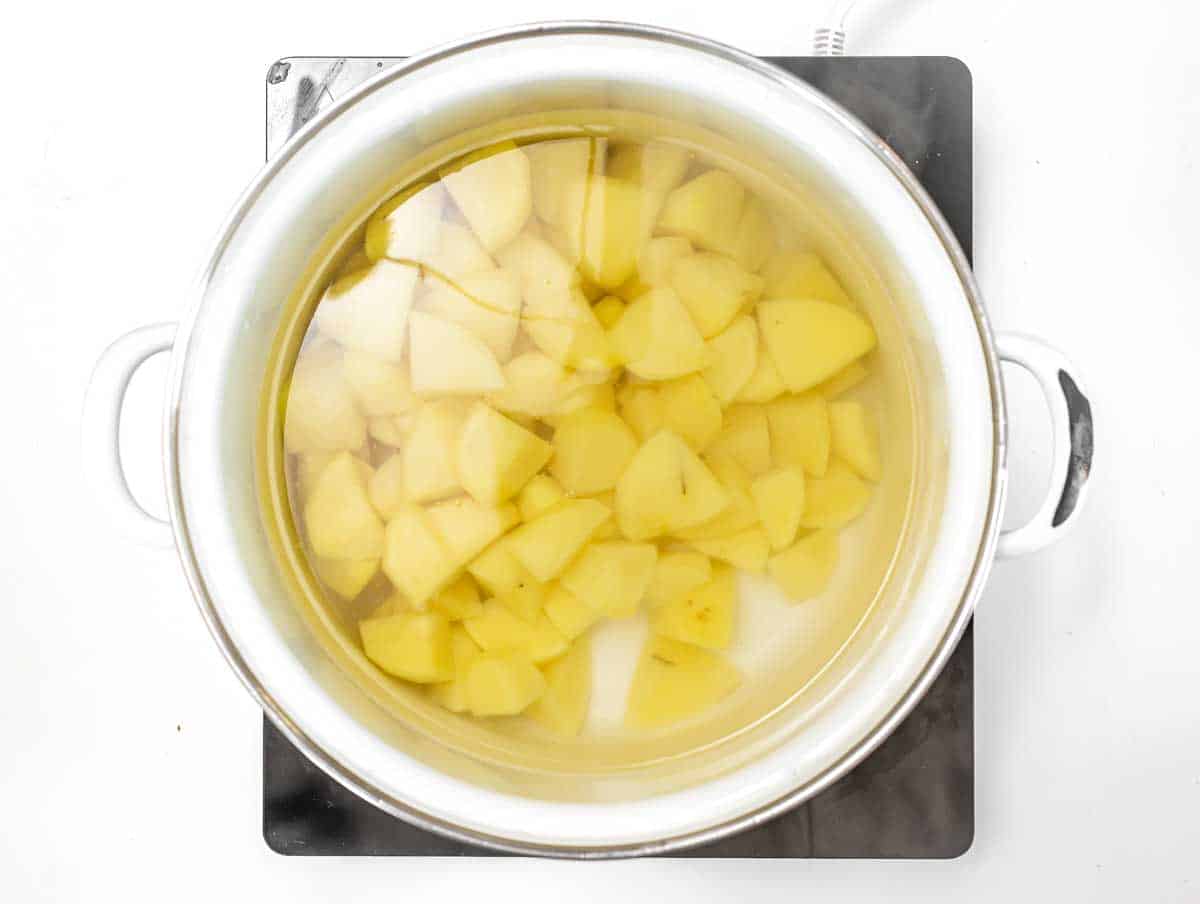 Boil potatoes in a pot