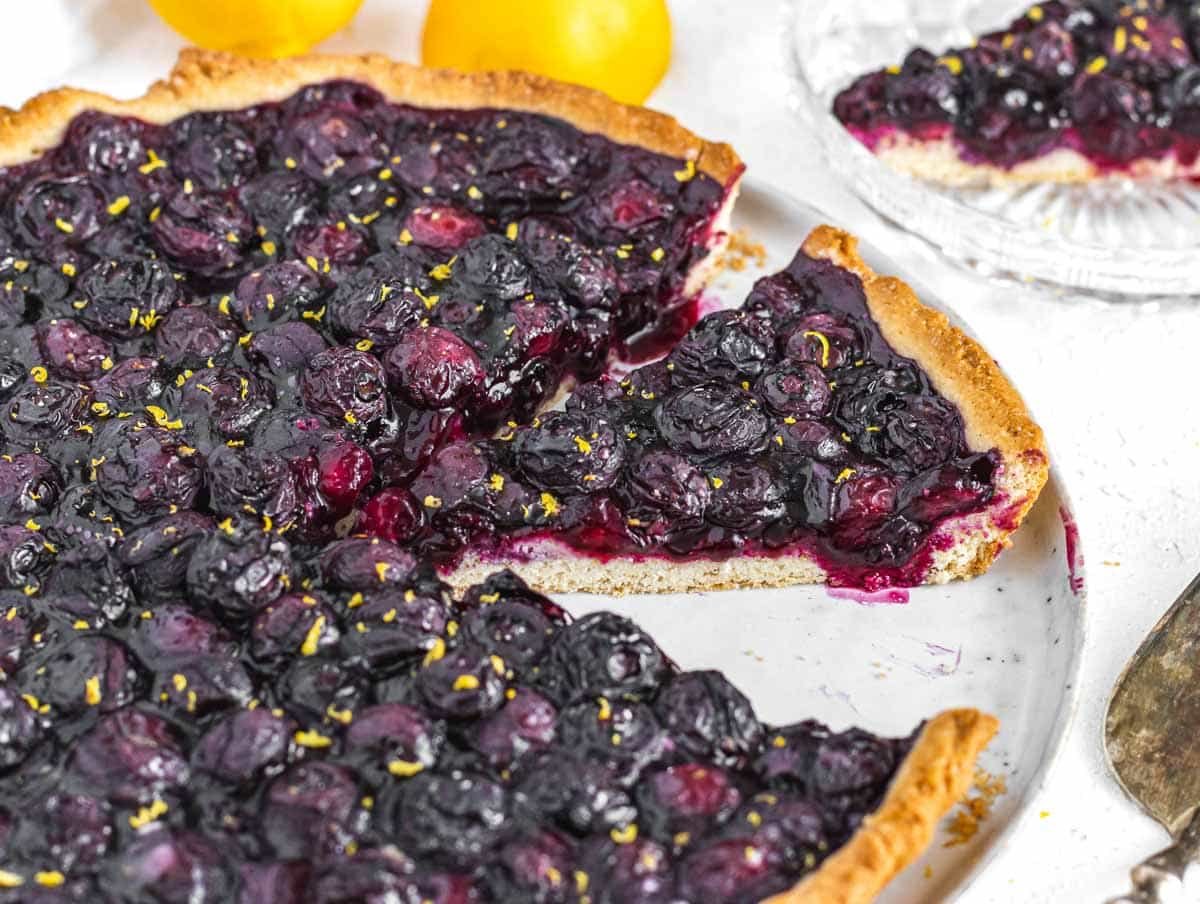 blueberry tart sliced on a plate