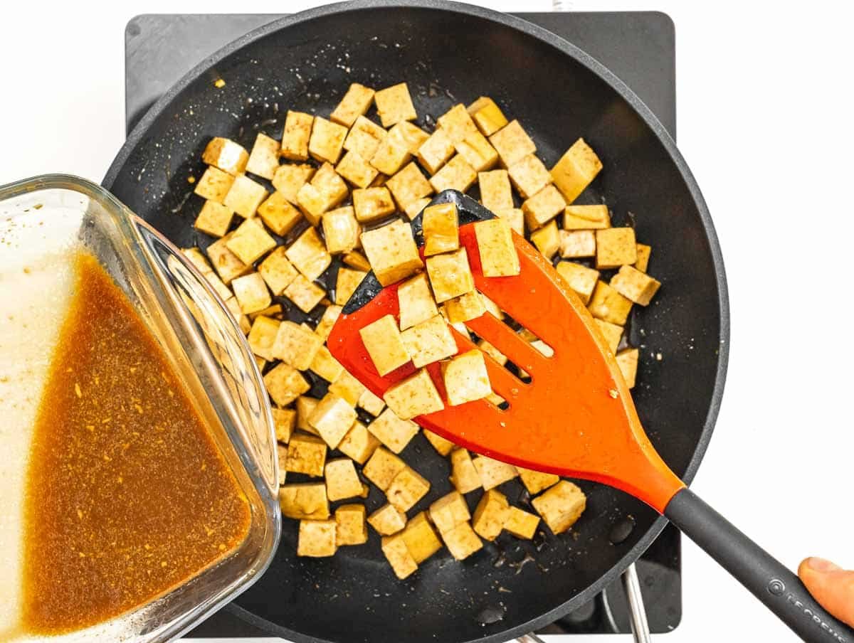 fry tofu on a pan with sauce