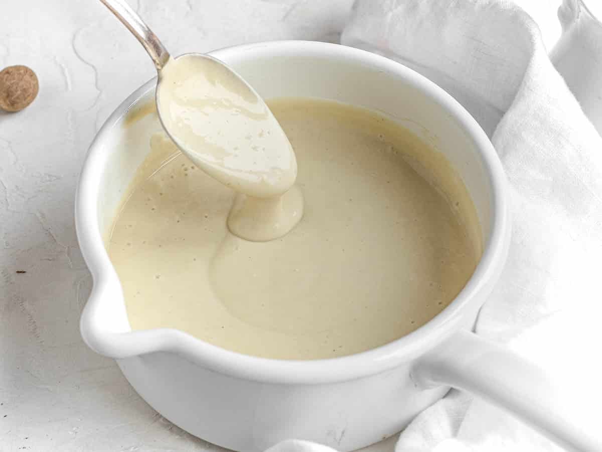 vegan white sauce in a white pot