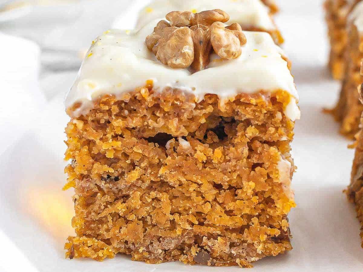 a square of vegan carrot cake with frosting