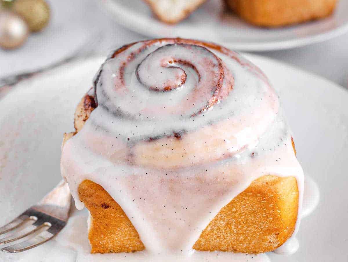 vegan cinnamon roll covered in icing