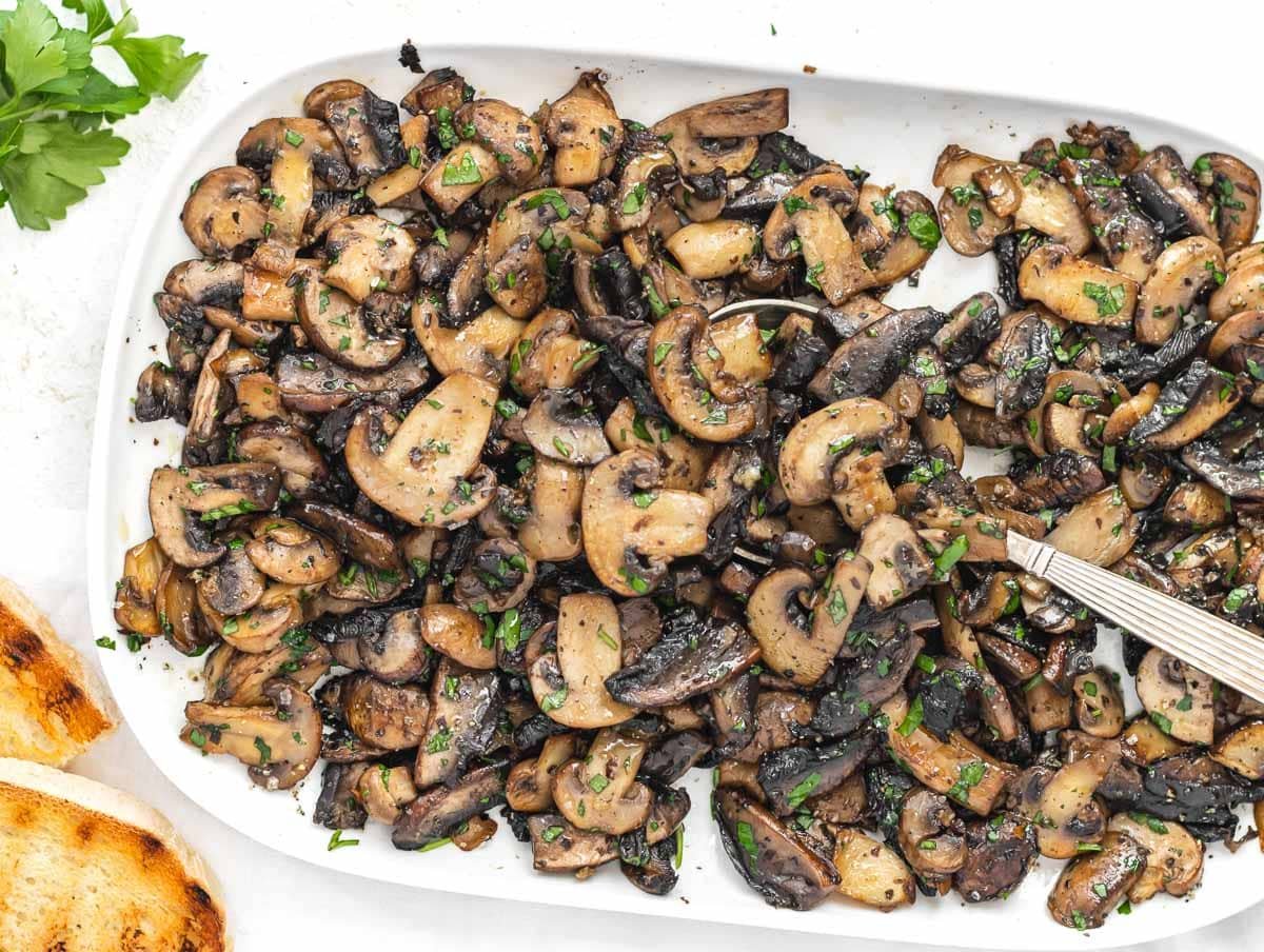 Sauteed mushrooms and white spoon