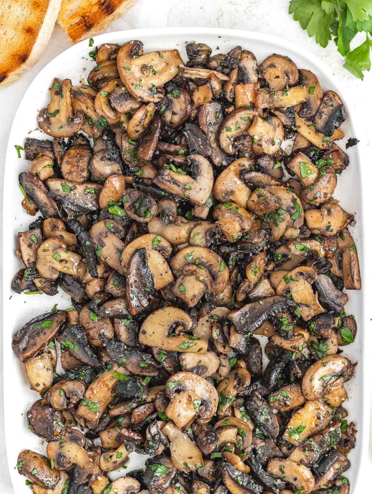 Sauteed mushrooms on a white platter
