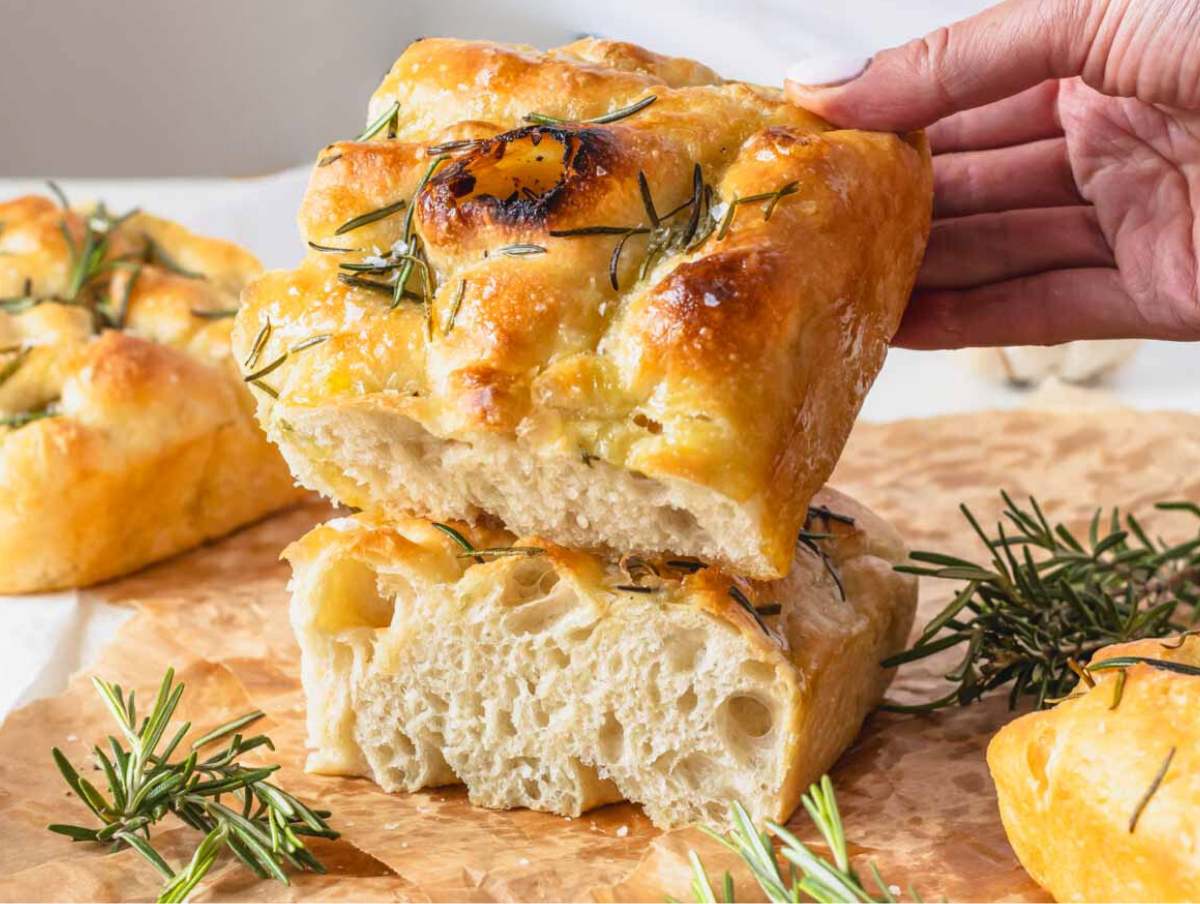 thick focaccia with a hand