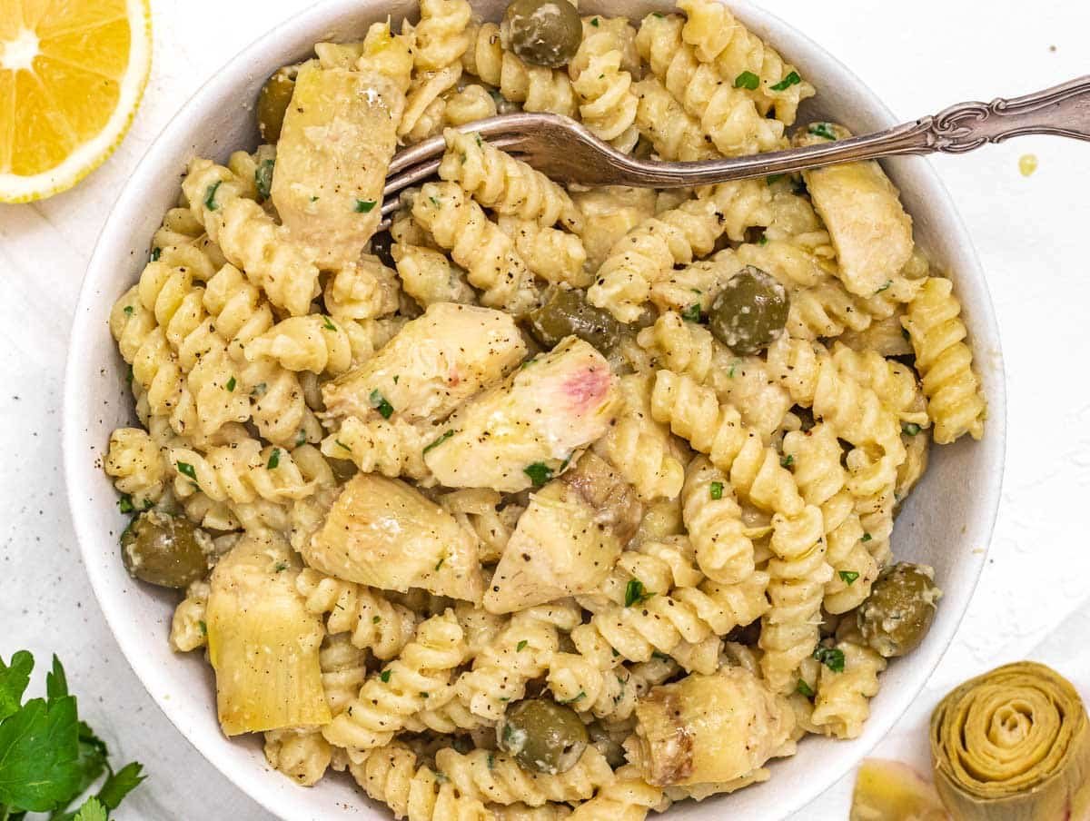 artichoke pasta in a bowl with a fork