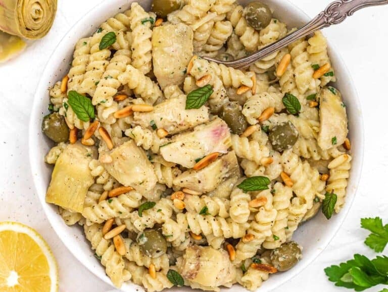 Artichoke pasta with fork and mint leaves
