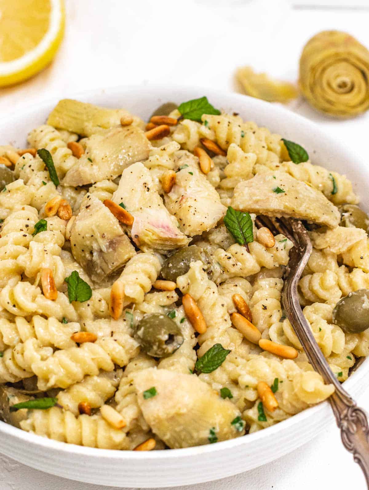 Artichoke pasta with fork and lemon