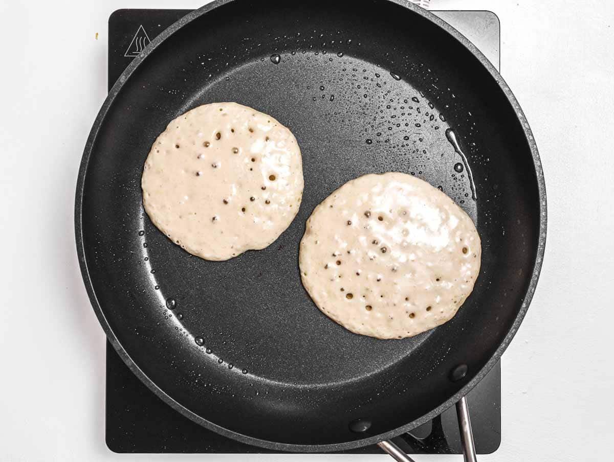 Pancakes with bubbles on a pan