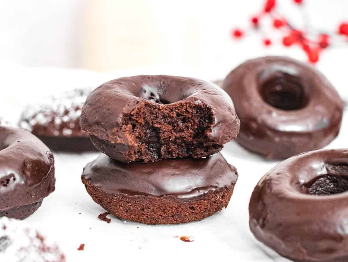 Chocolate donuts with glaze and a bite