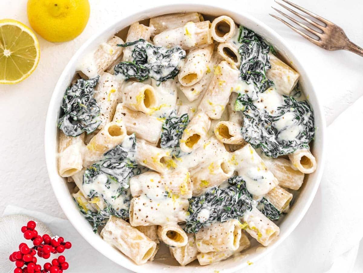 Creamy Kale Pasta with fork and lemon