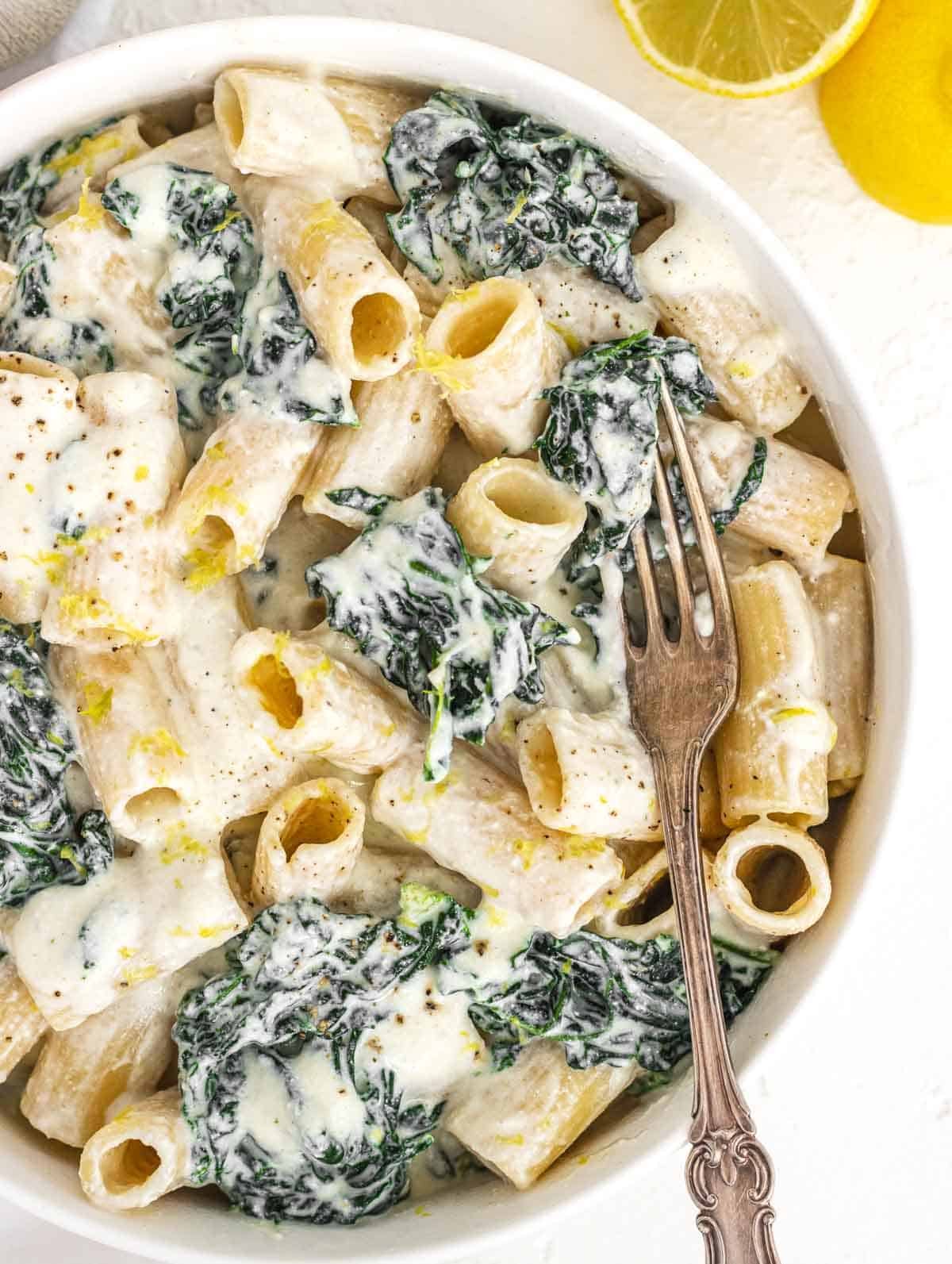 Creamy kale pasta in a bowl with fork