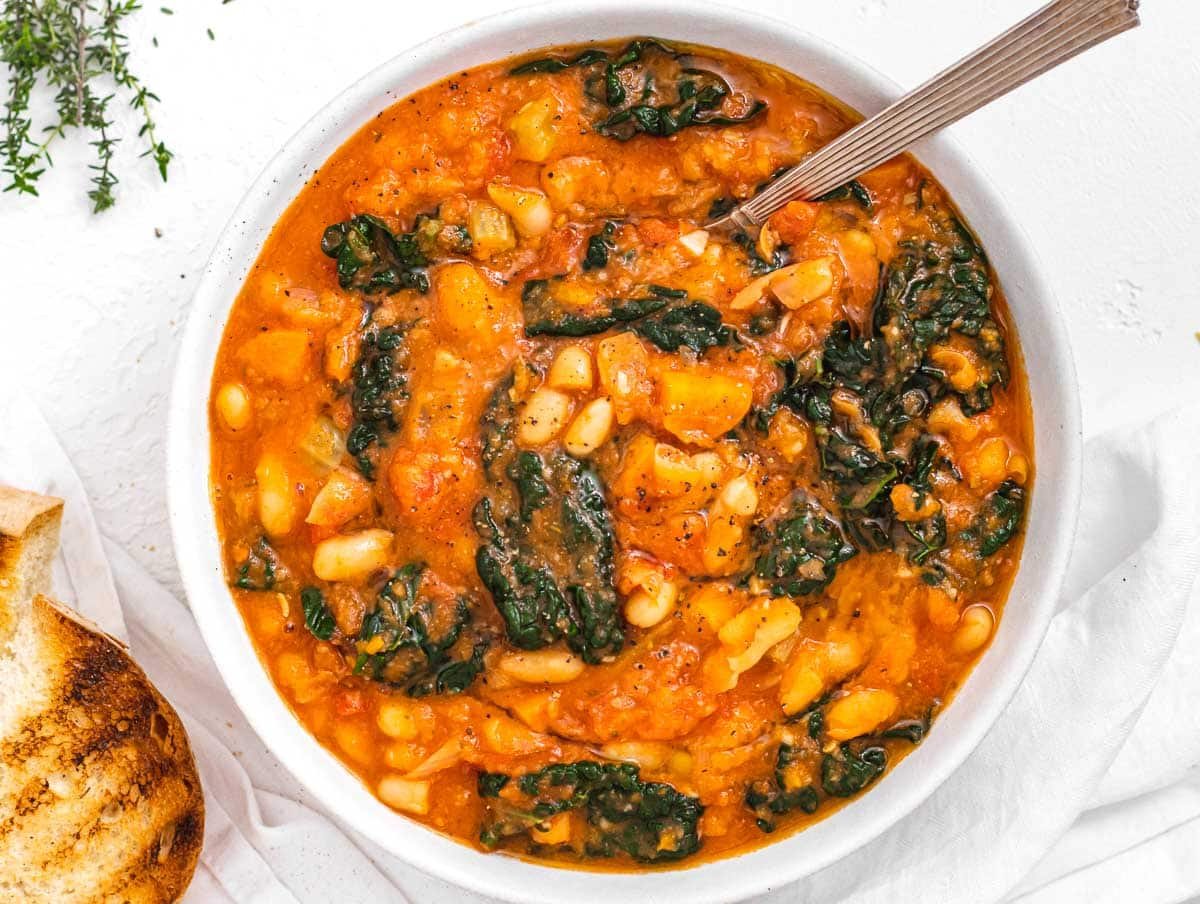 Kale soup with spoon and bread