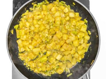 fried leek and potato in a pan