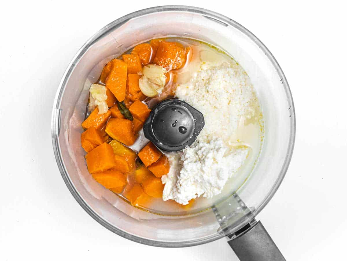 food processor with roasted pumpkin and cheeses