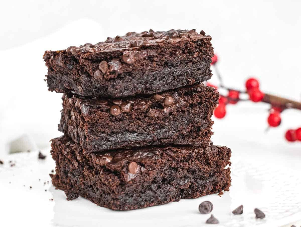 Vegan brownies stacked on white plate