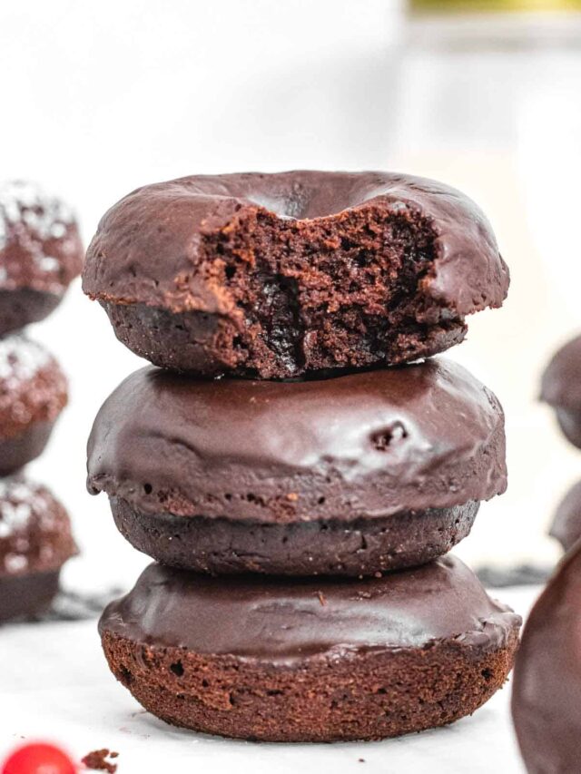 Chocolate donuts with glaze and bite