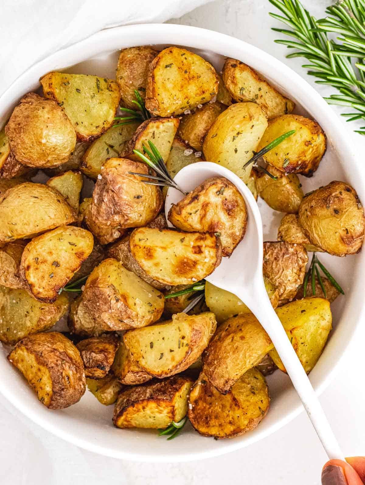 Air fryer potatoes with white spoon