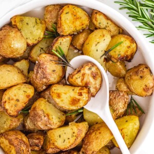 Air fryer potatoes in a bowl with spoon