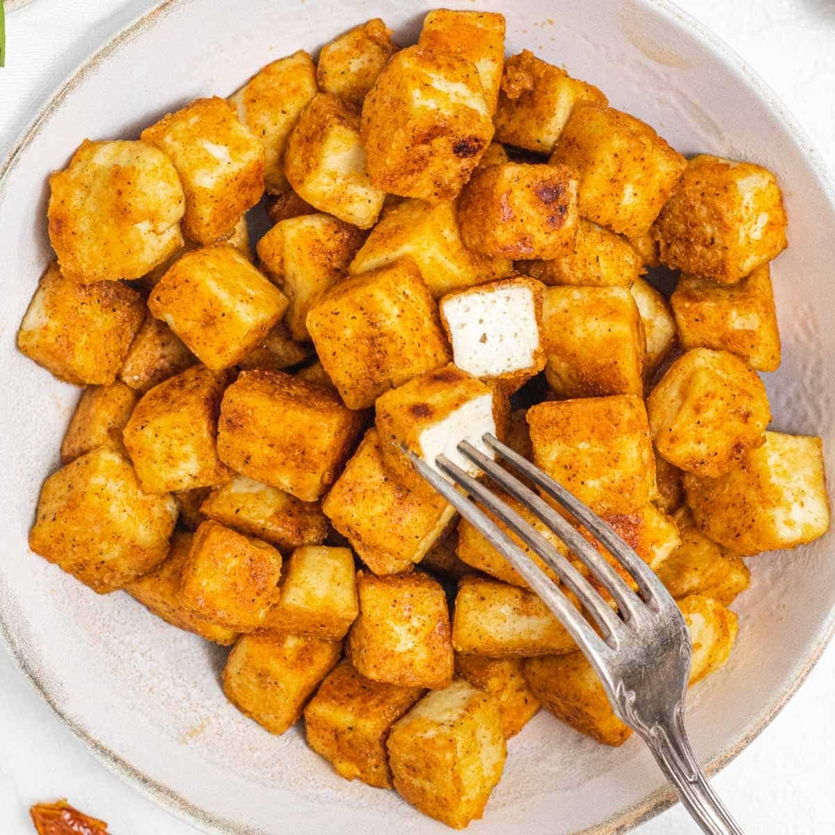 Fried tofu with fork