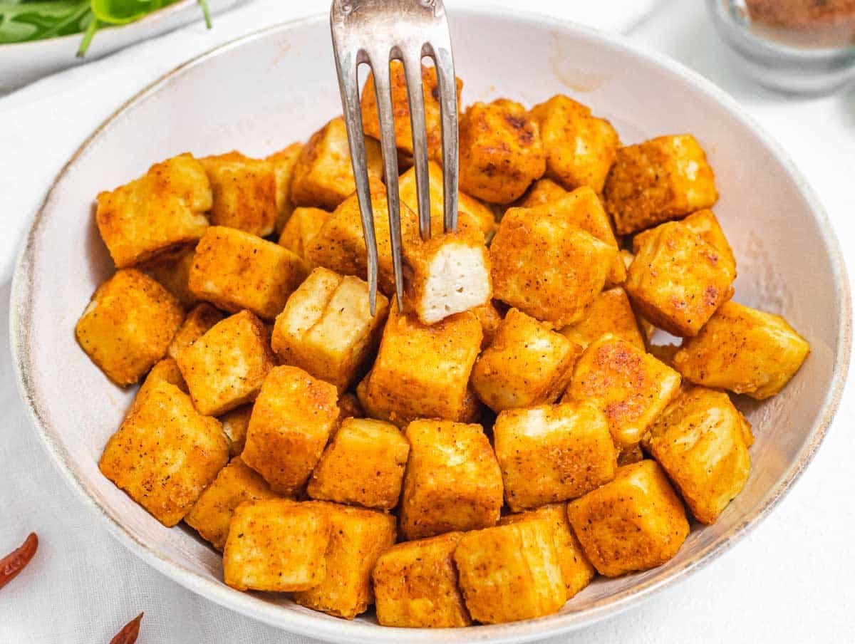 Fried tofu with a silver fork