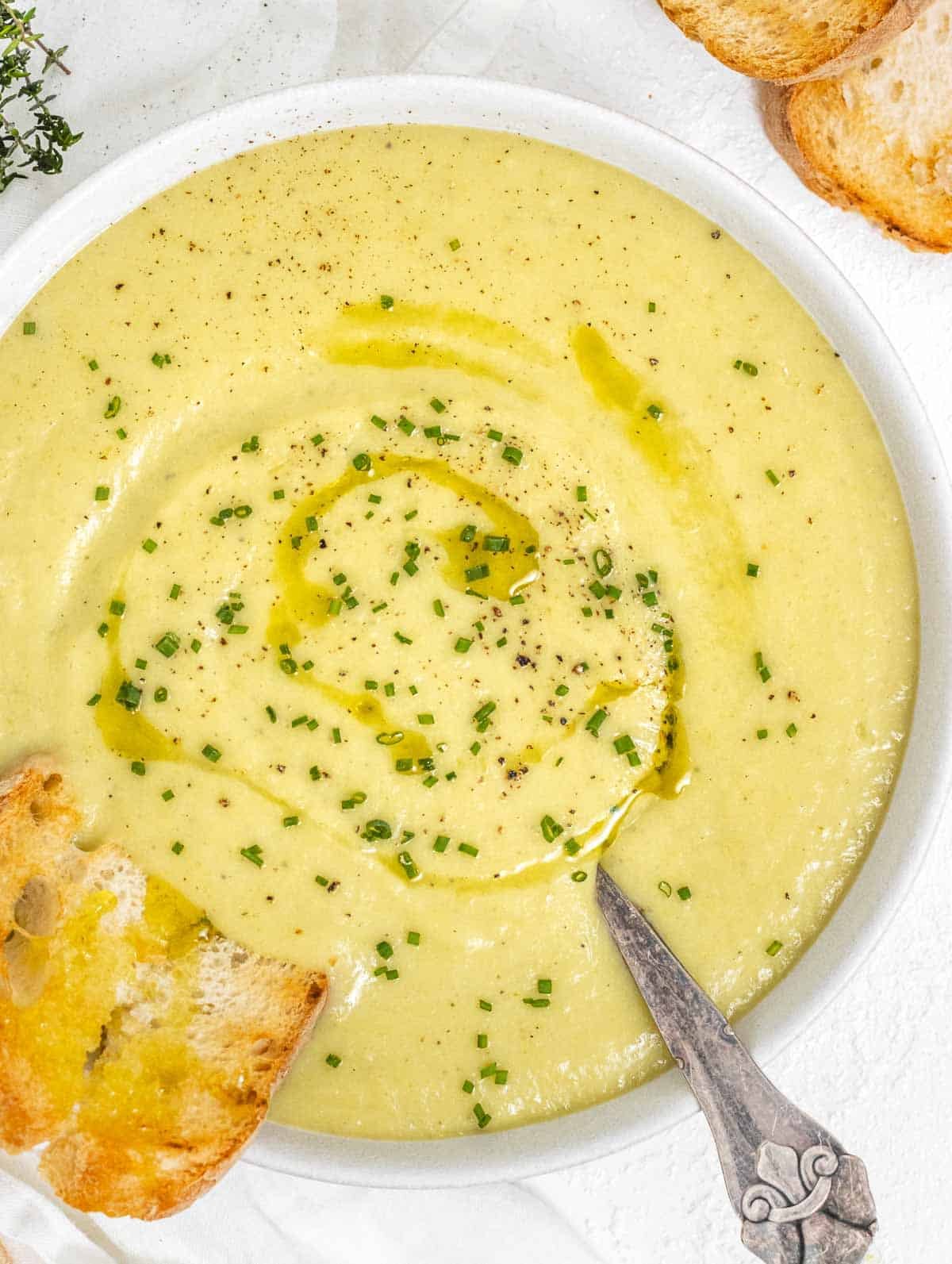 Potato leek soup with spoon and bread
