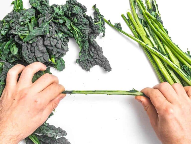 hands and kale leaves