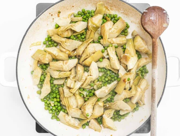 artichoke and peas in a skillet