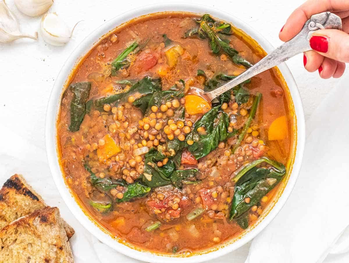 Lentil Vegetable Soup with a spoon held by Louise