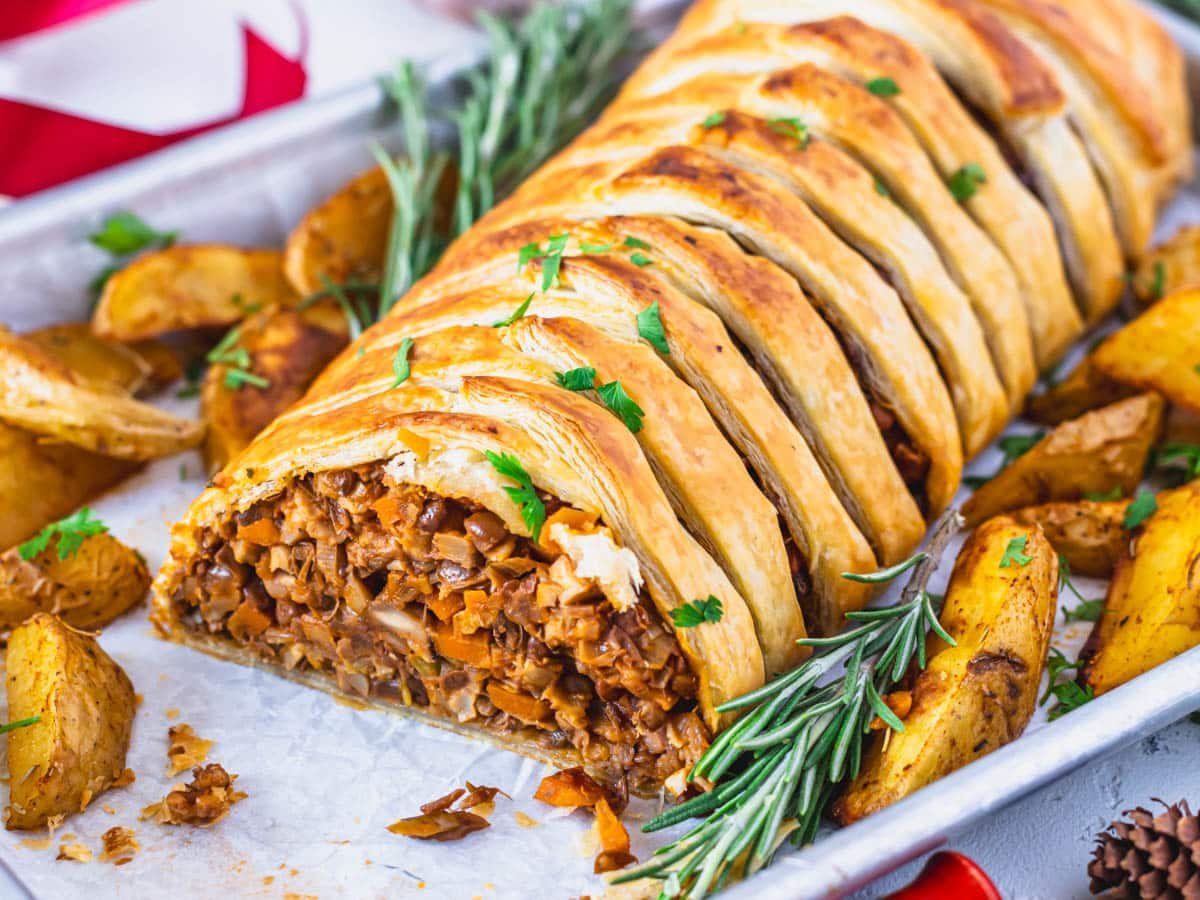 Mushroom Wellington recipe with lentil filling and roasted potatoes on the side