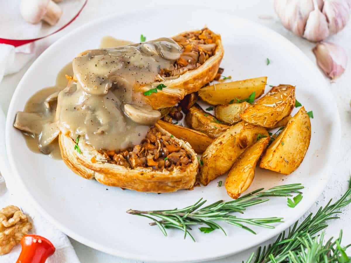 Mushroom wellington and gravy on a white plate