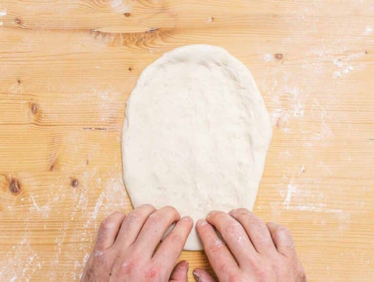 stretching dough with hands