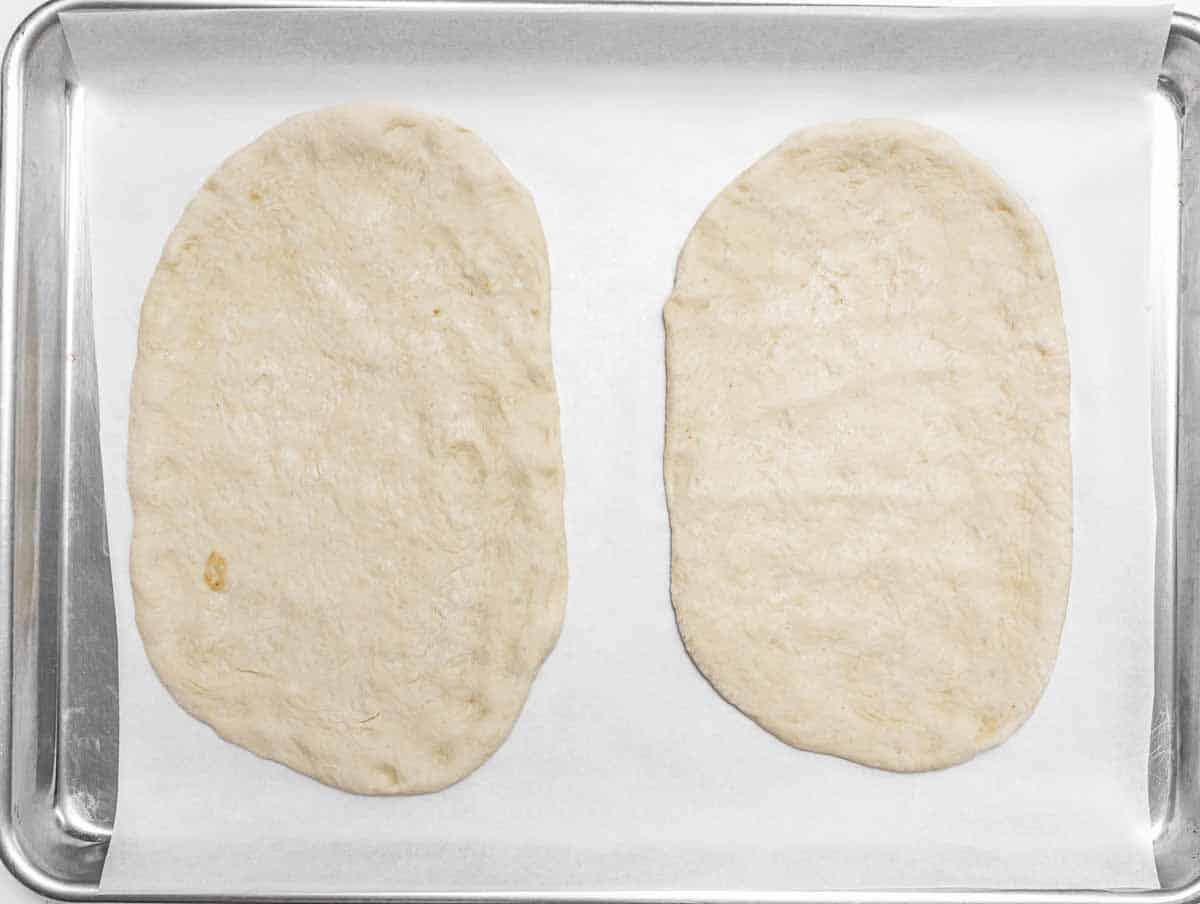 Naan bread on a baking tray