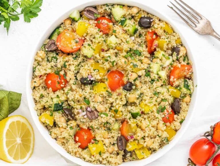 Quinoa chickpea salad with fork and a lemon