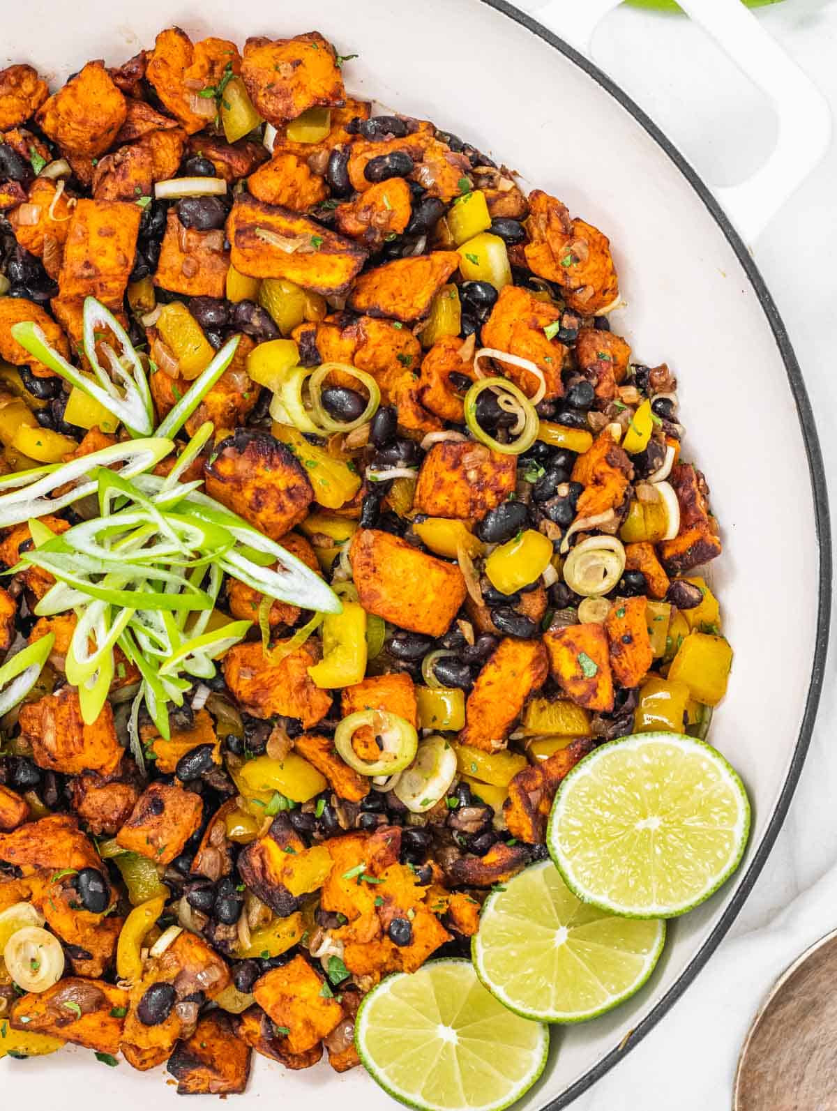 Sweet potato hash in a skillet with lime