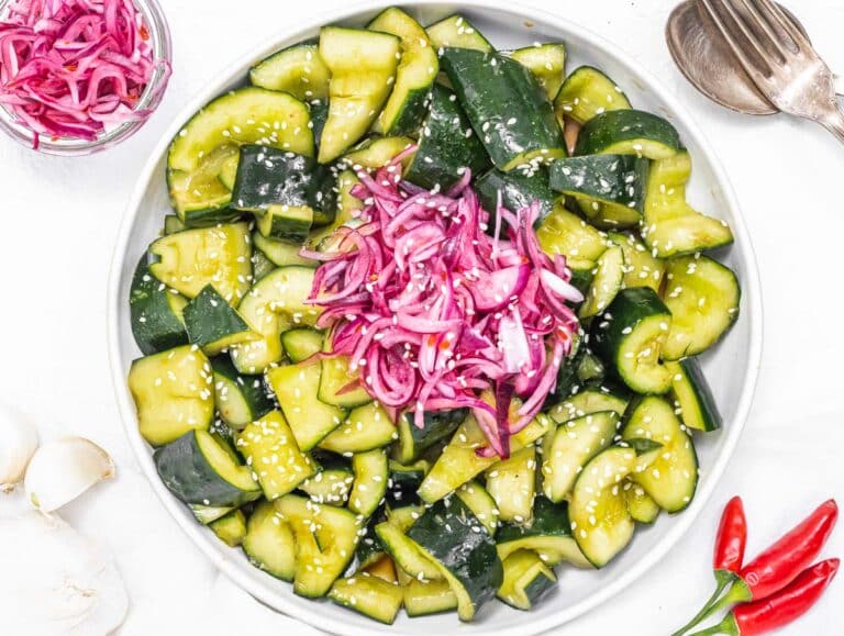 Asian cucumber salad with pickled red onions and fork