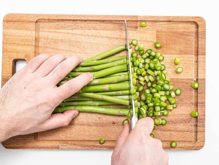 Hands with knife and asparagus