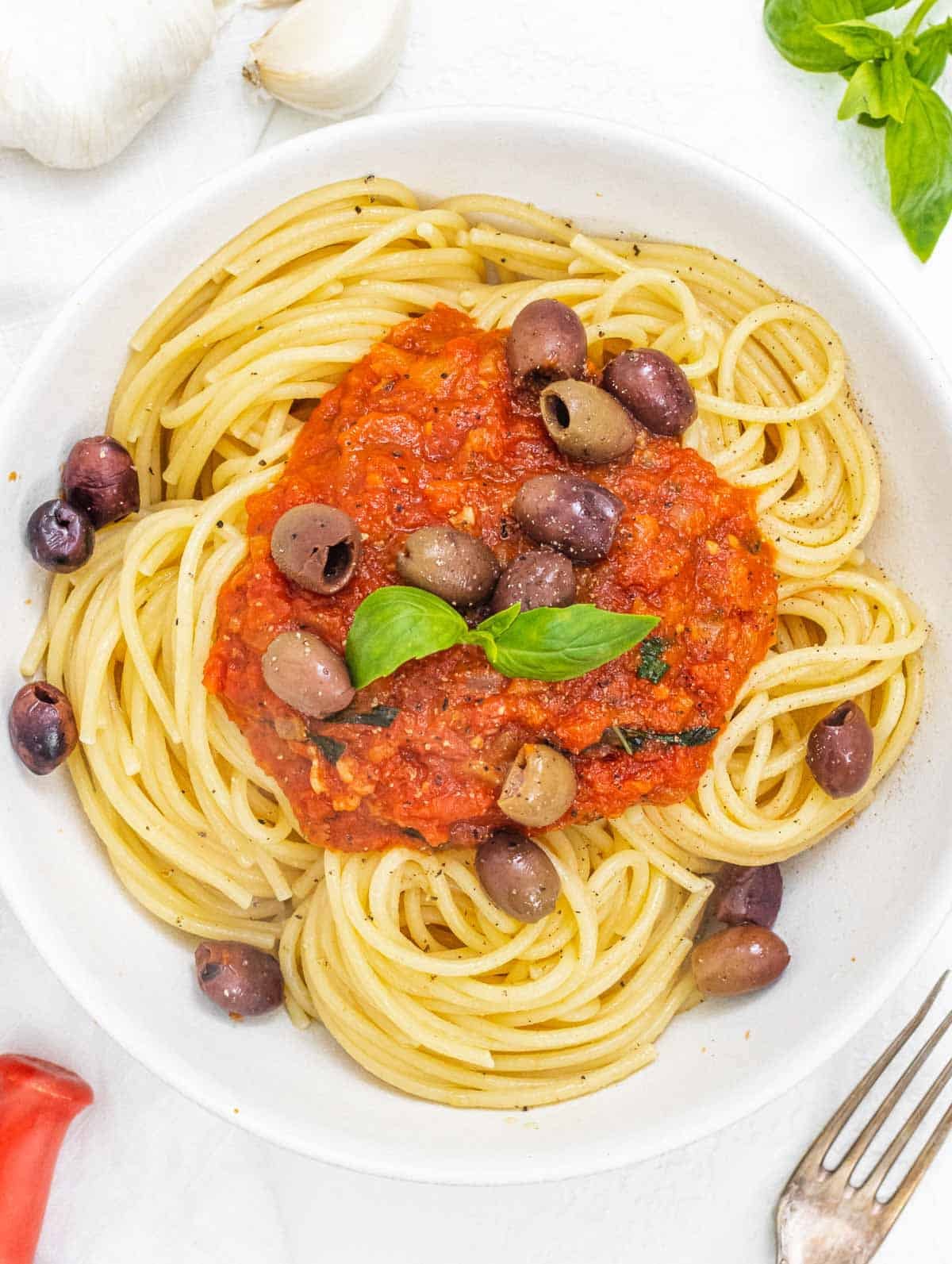Marinara sauce on spaghetti with olives