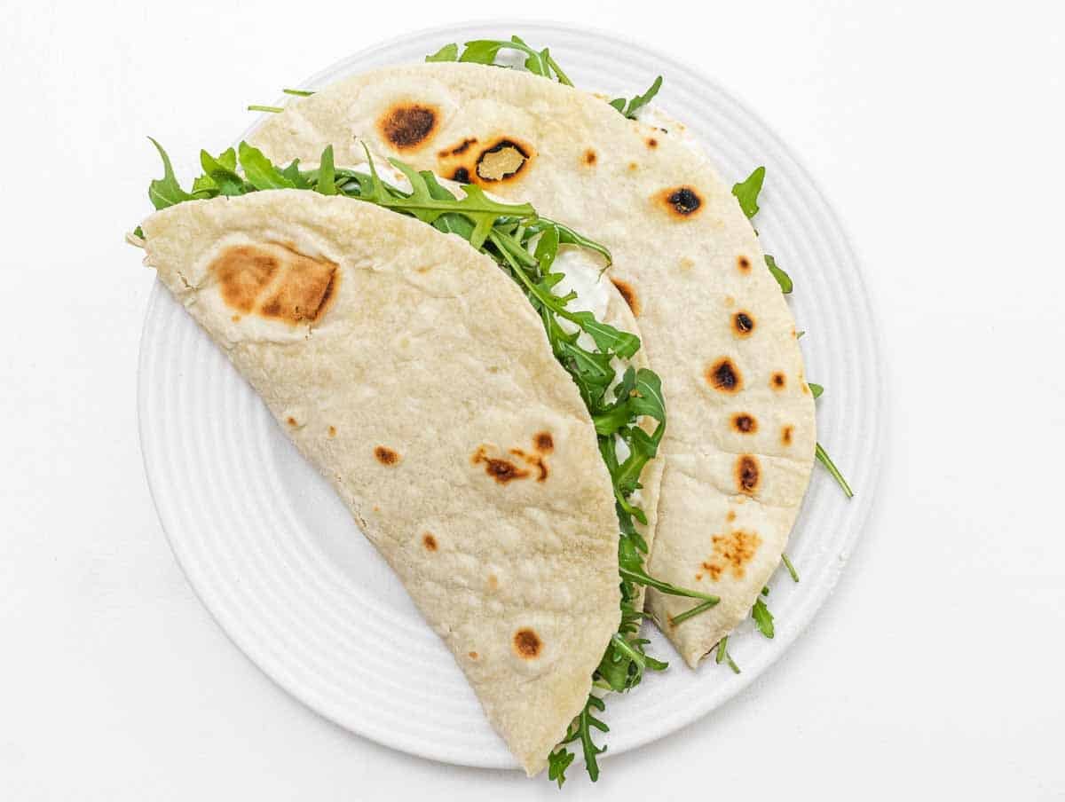 Piadina on a white plate with filling