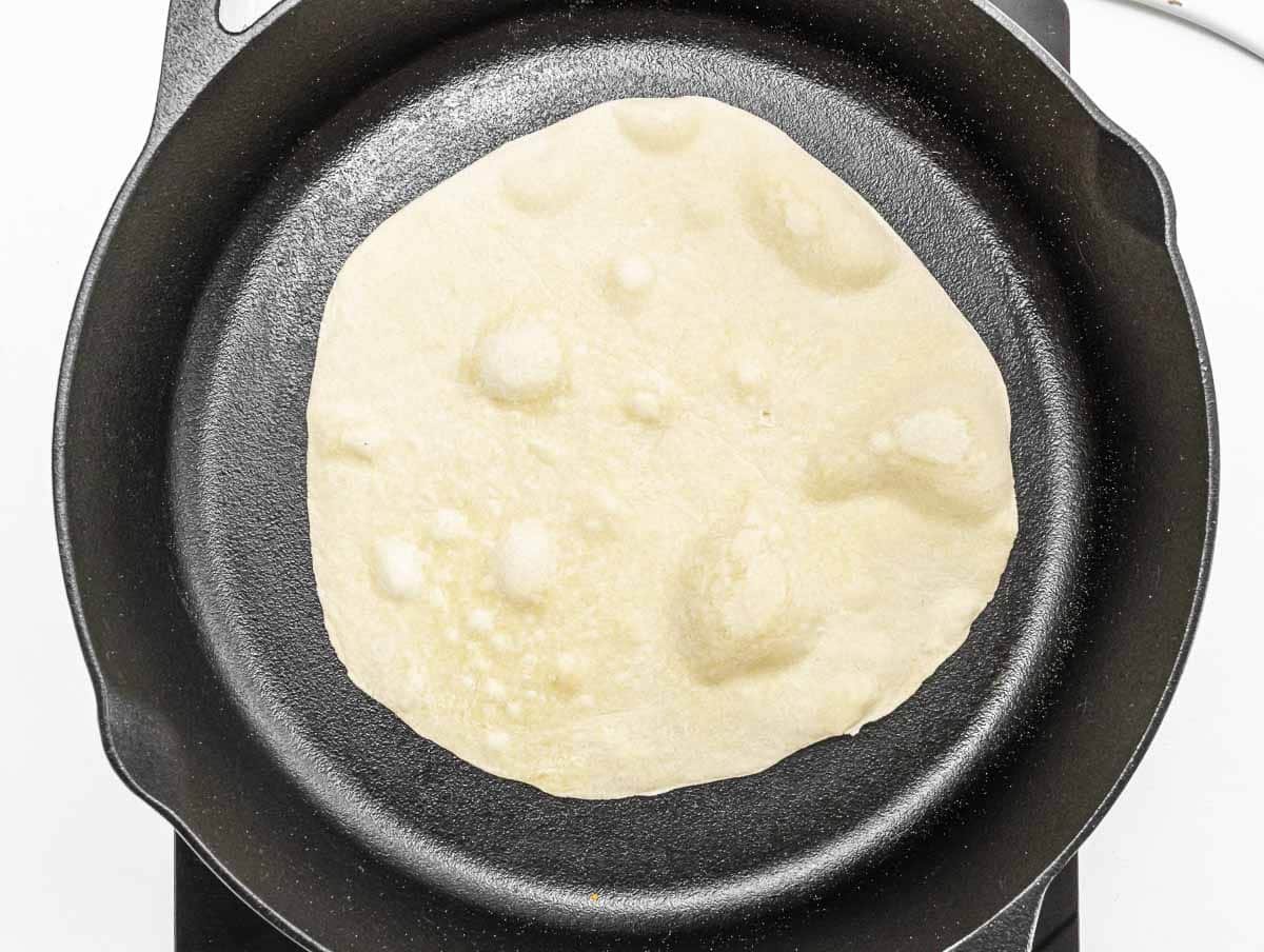 cooking the piadina on a cast iron skillet