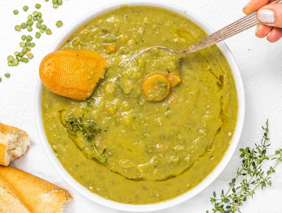 Split peas soup with hand and baguette