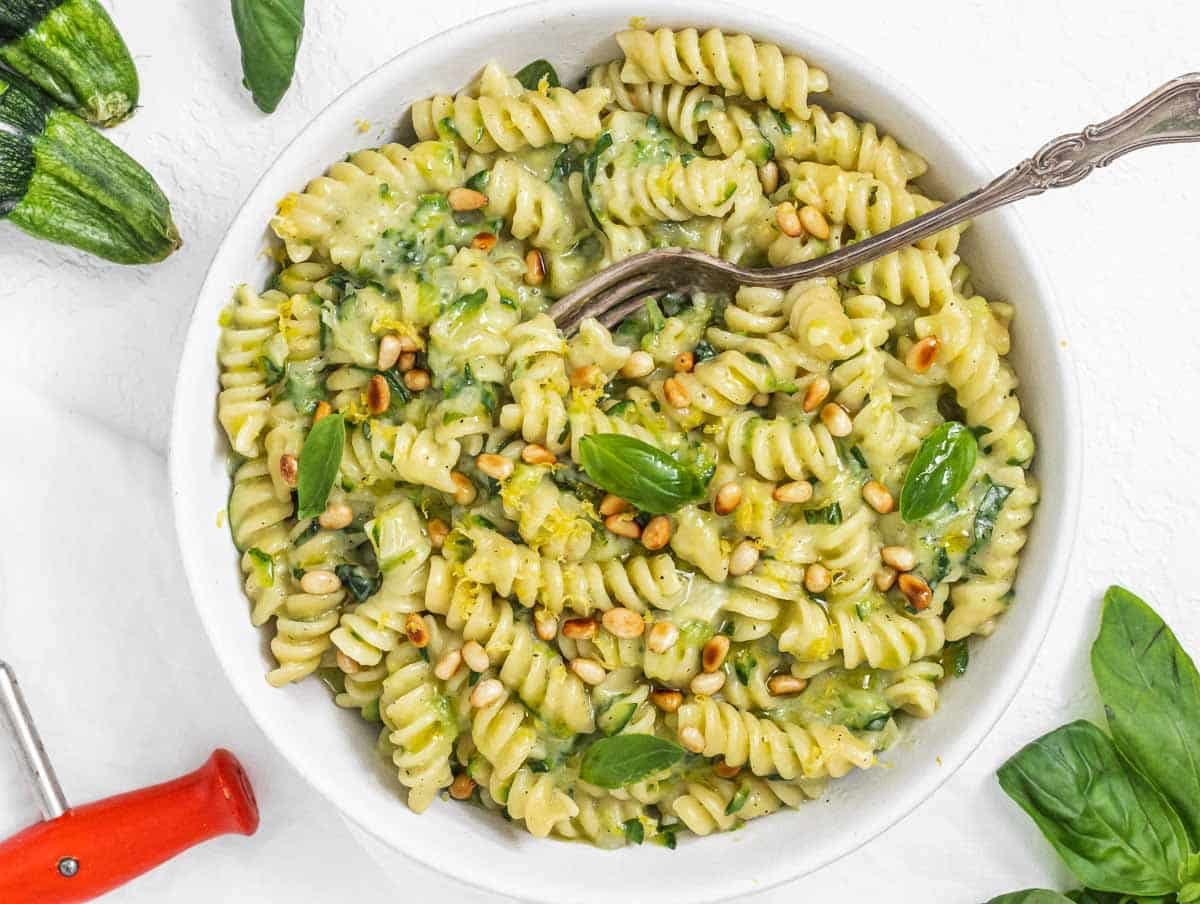 Zucchini Pasta with fork and pine nuts