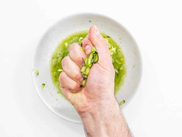squeezing zucchini juice in a hand