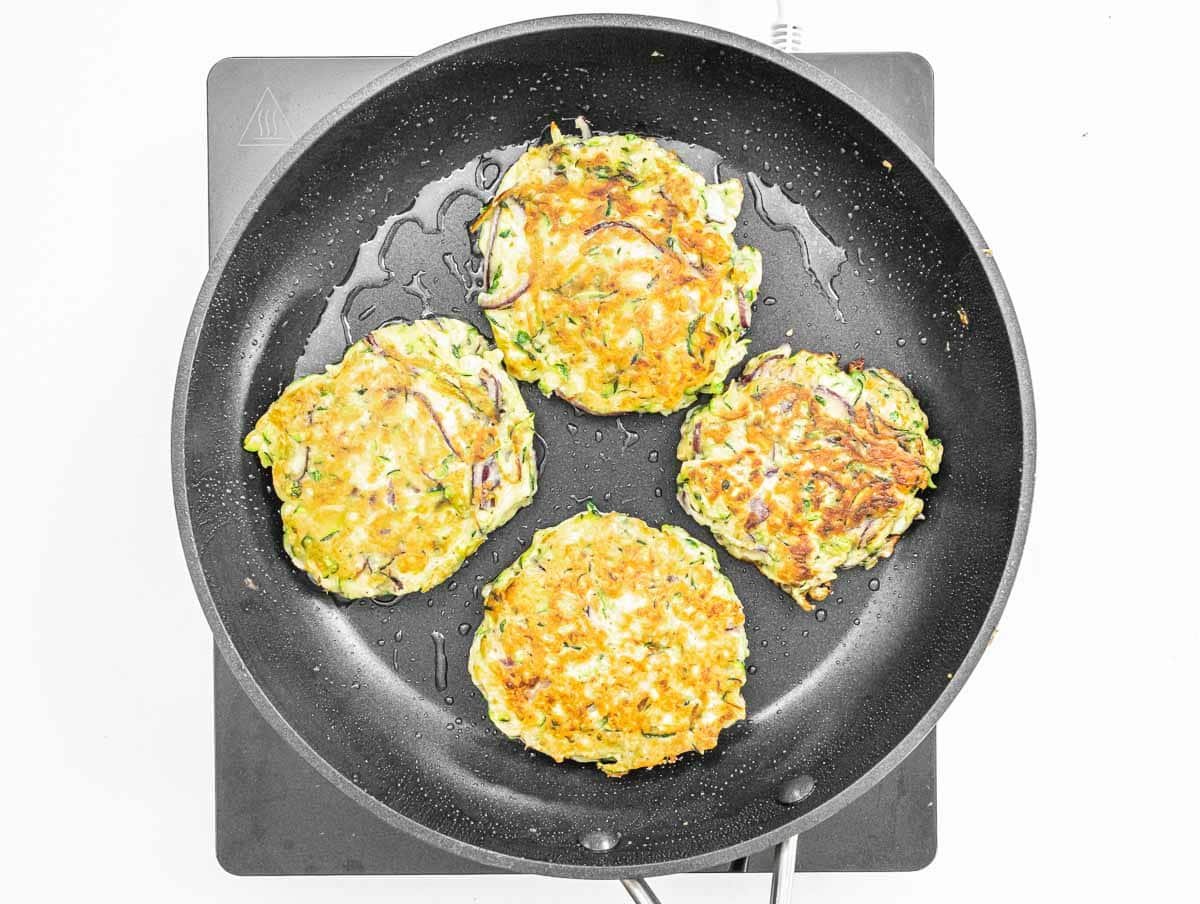 Cooked zucchini fritters in a pan