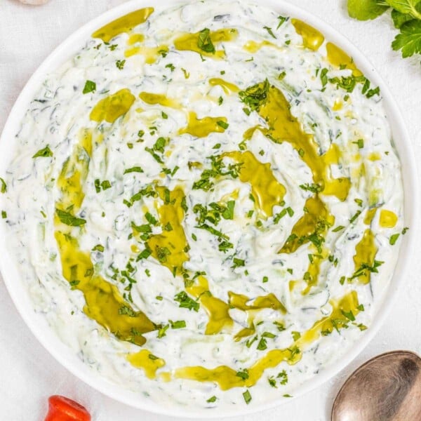 tzatziki with fresh herbs and a spoon